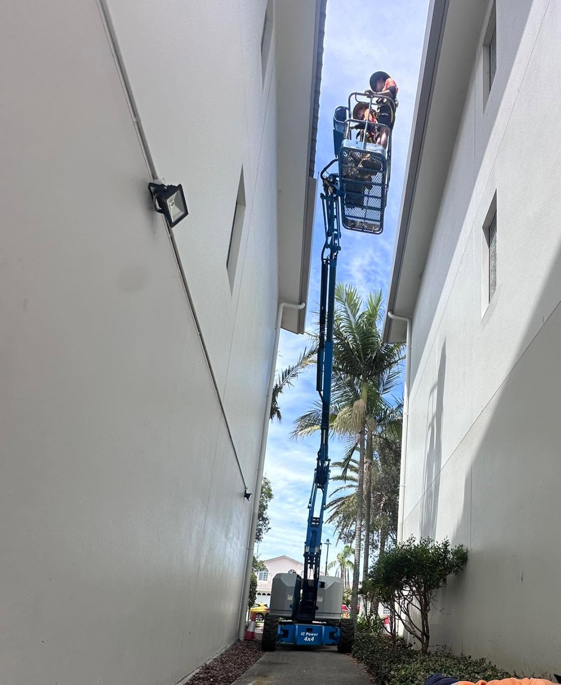 CCA plumbing team working at height between local buildings